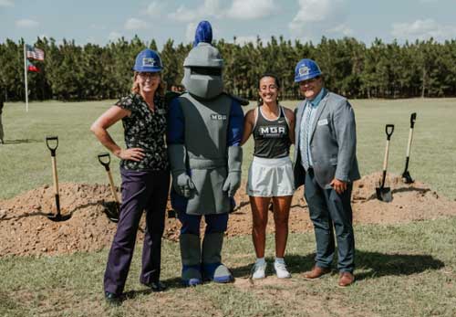 MGA representatives pose for a photo with Duke. 